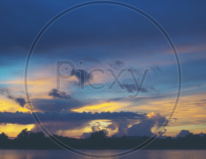 Landscape With Sunset Sky And Clouds Over a Tropical Lake Background