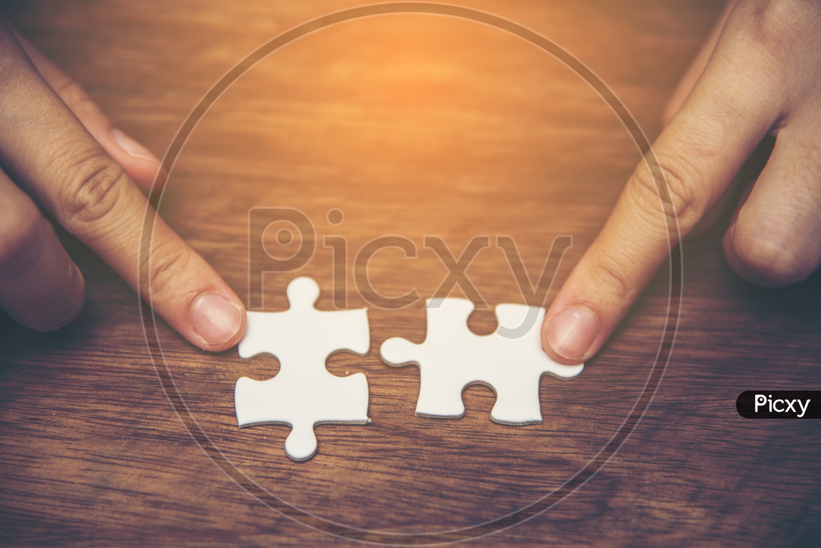 Close up of hand holding the jigsaw puzzle pieces, Hand holding missing jigsaw puzzle piece down in to the place, conceptual of problem solving, finding a solution