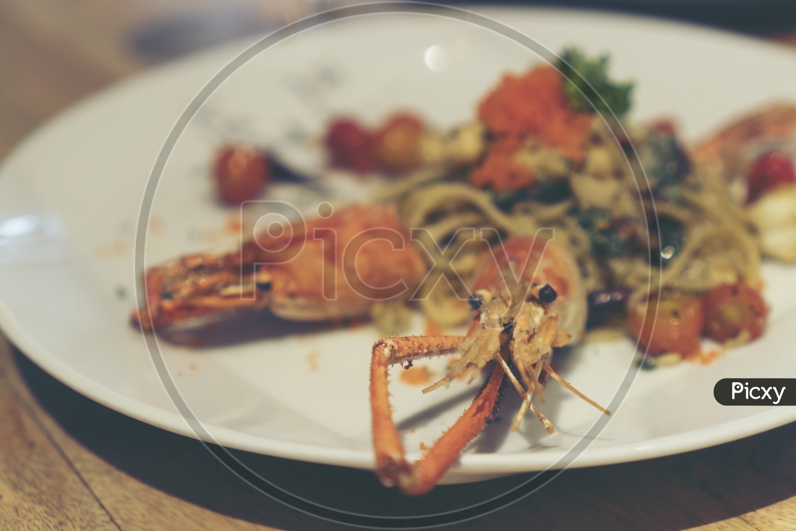 Spaghetti with shrimp and herbs on a  Restaurant Plate Closeup