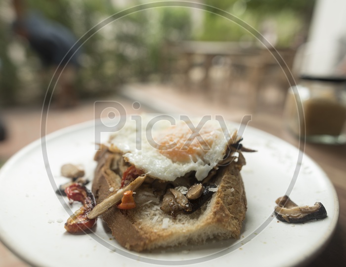 Thai Breakfast With Bread Omelet  and Beef Pieces Served At a Restaurant Table Background