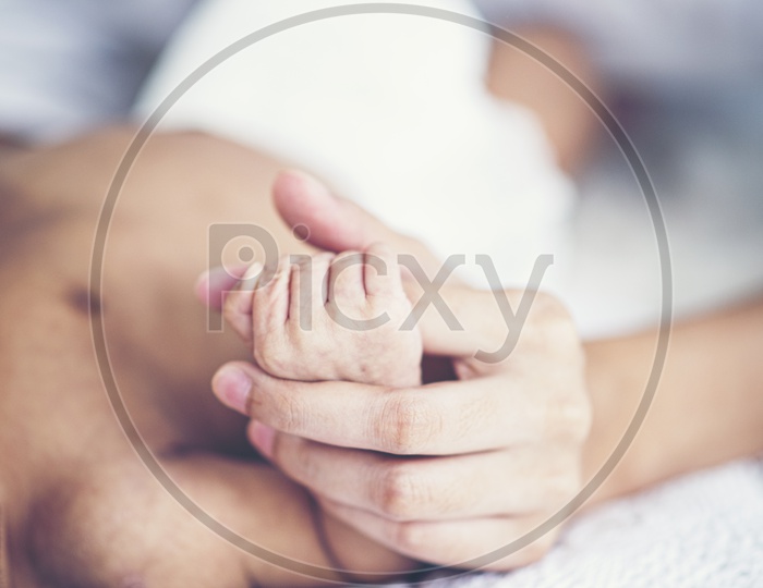 Mother holding baby Hand Closeup