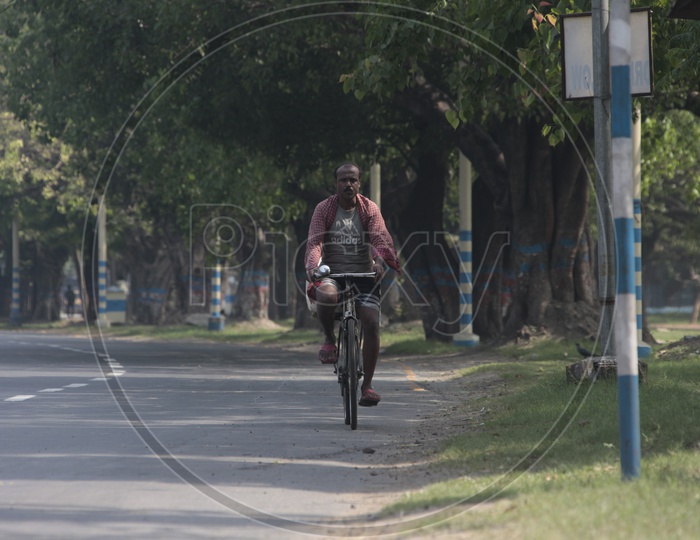 Indian Man Riding a Bicycle on the road