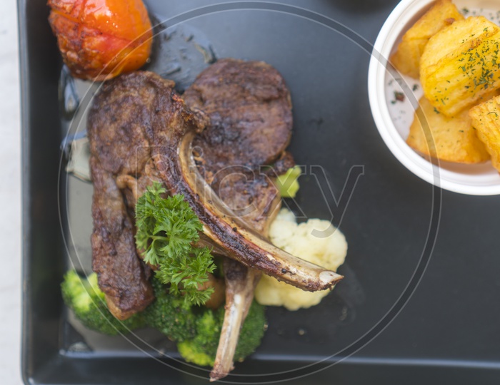 Grilled Lamb Steaks Served With fresh Broccoli