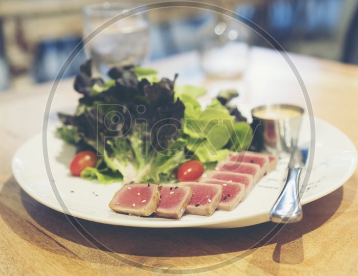 Seared Ahi Tuna Steaks Served With Fresh Green Vegetable Salad