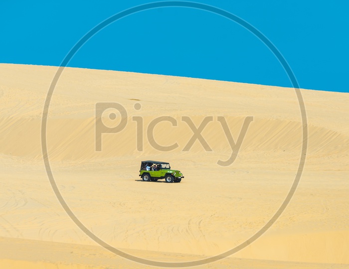Tourists enjoy on the desert by jeep car Rides  in Mui ne , Vietnam