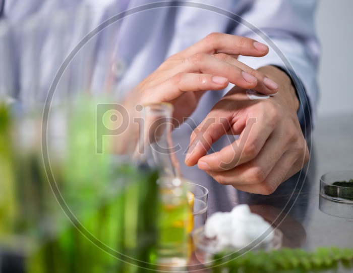 Asian Research Scientist Testing Skin for the development of Cosmetics