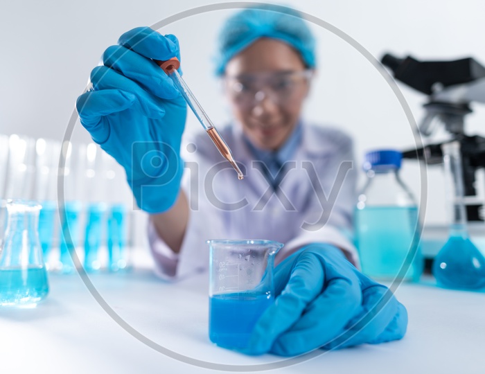 Asian Woman Scientist or Medical Student Working Chemical Solutions at Laboratory