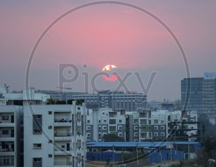 Sunset Over Buildings With Street Views