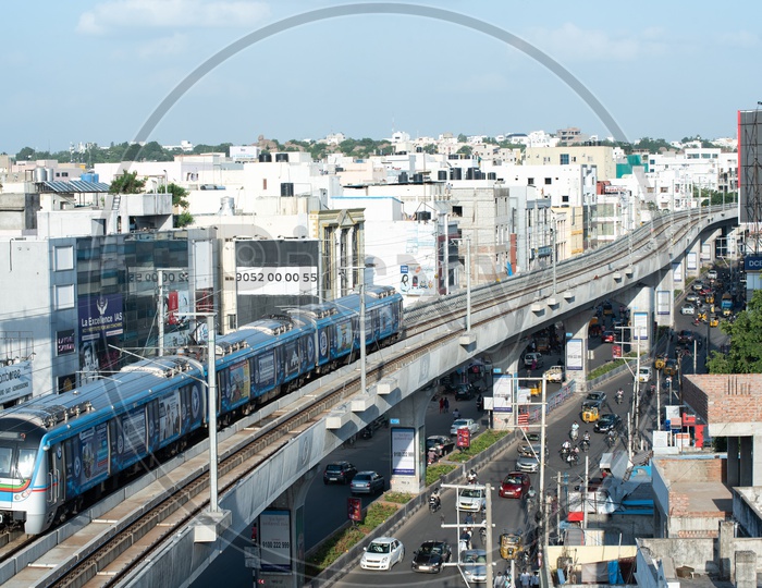 Image of Metro train Running On Track Top View With Commuting Vehicles