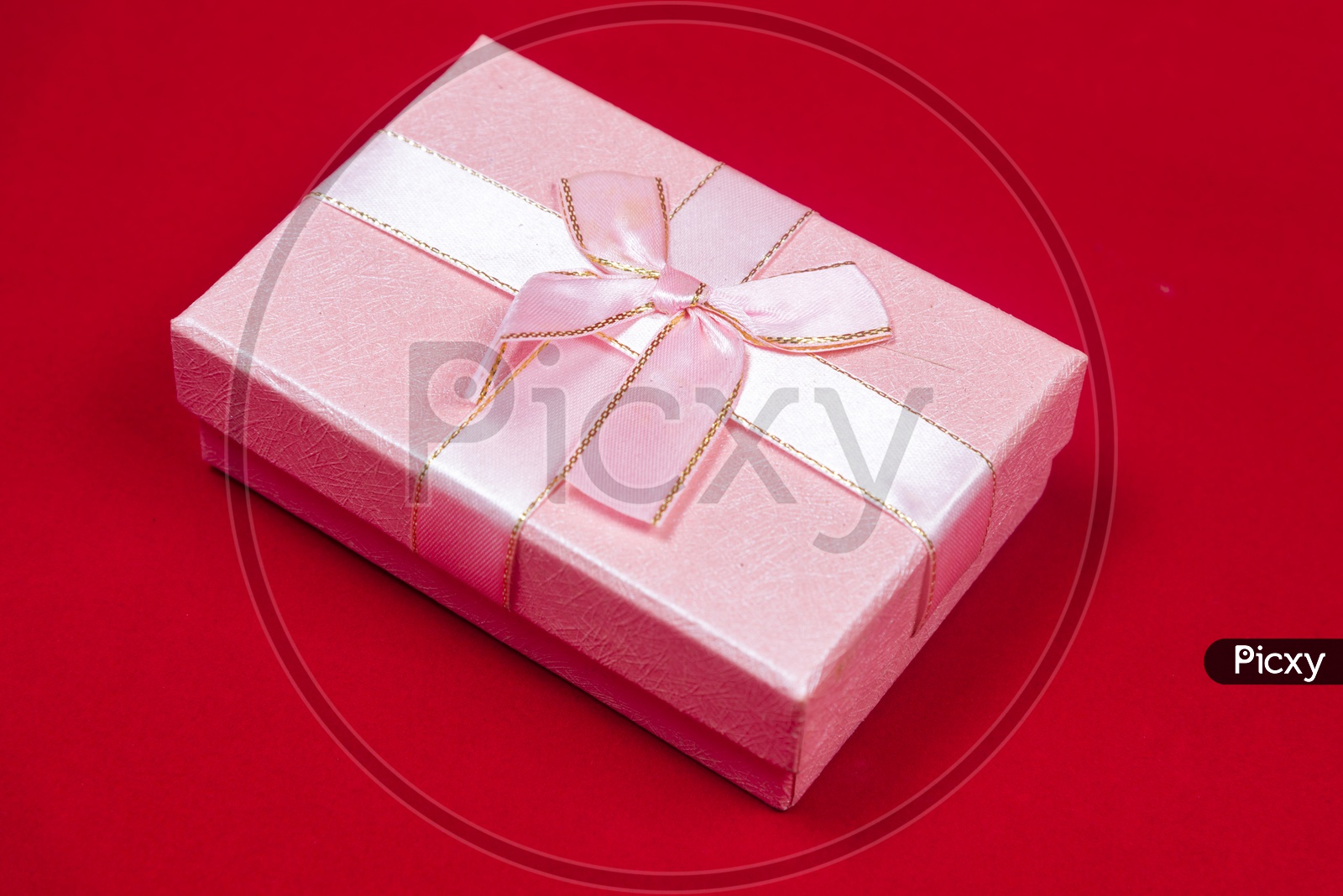 A pink gift box on a red background - Art picture background of Love