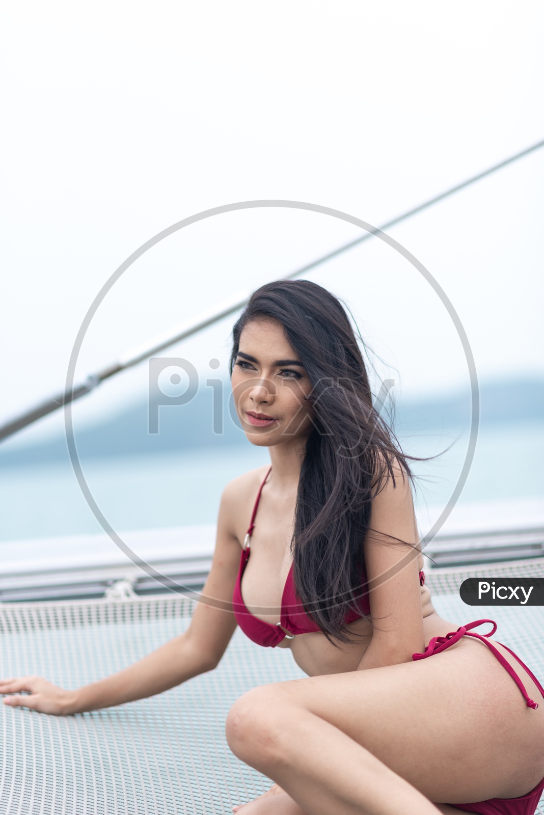 Image of Asian Beautiful girl in Red Bikini on a yacht in Sea-VS911001-Picxy