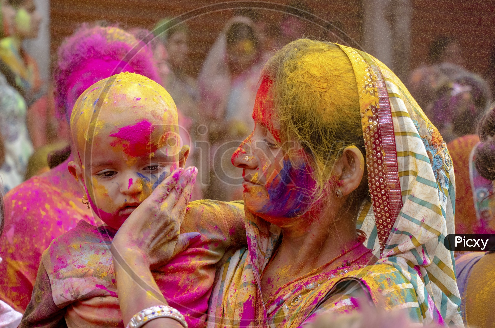 Indian Mother Celebrating Holi With Child