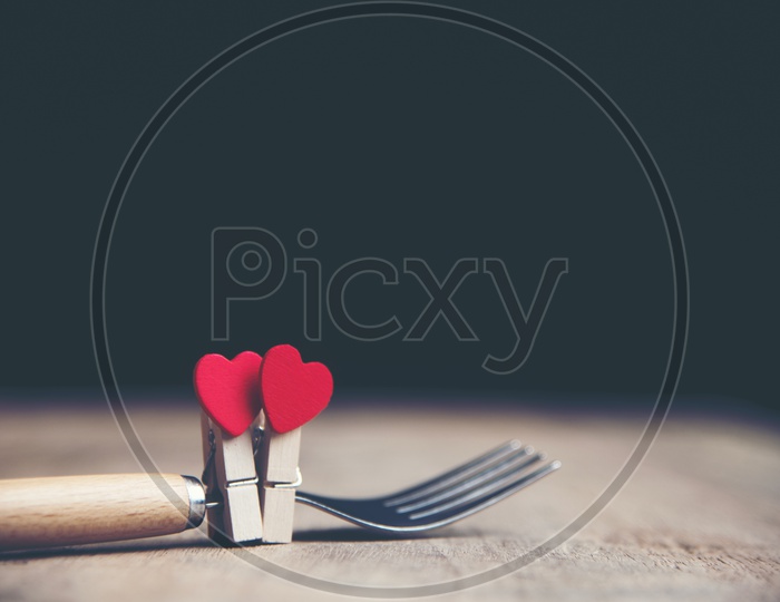 Heart Shape Couple Tagged  To a Fork  On a  Isolated Black Background  With vintage Filter