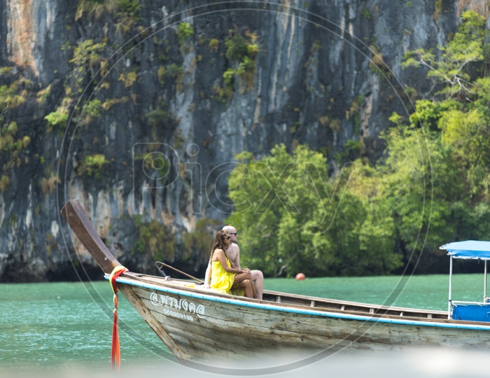 Tourist Couple Enjoying The Boat Rides At Phuket beach in Thailand