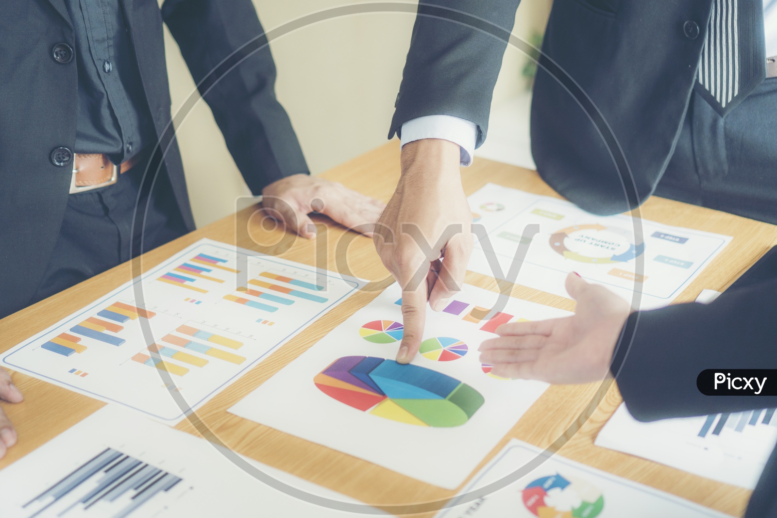 Business Entrepreneurs Discussing Business Plans With Growth Data With Charts And Figures on a Office Desk Closeup