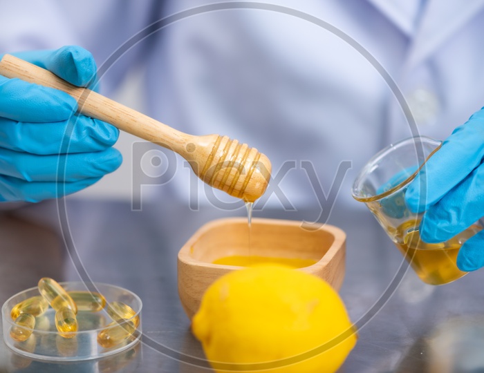 Young Asian Woman Scientist Holding Fish Oil Pill Or Capsule