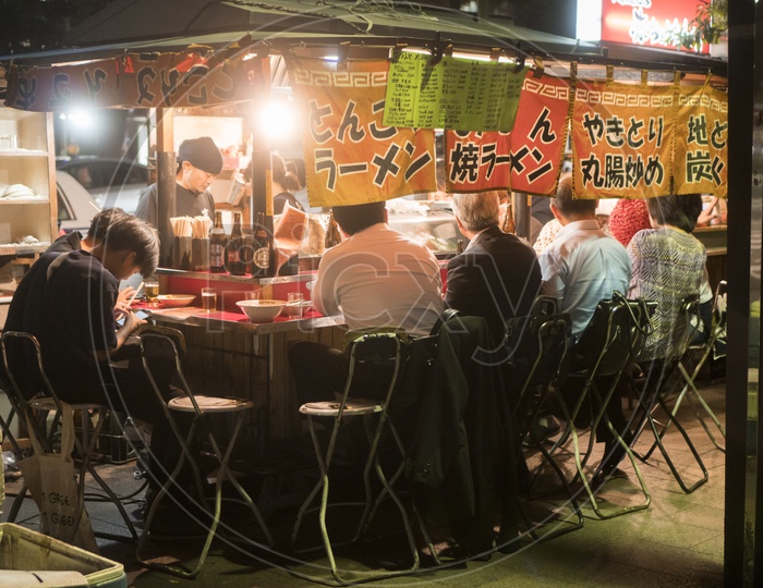 Japanese People at Yatai mobile food stall during night in Fukuoka, Kyushu, Japan