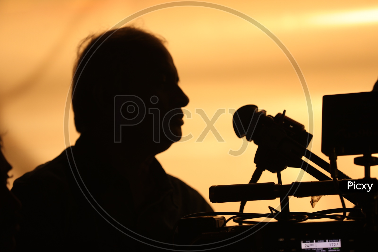 Silhouette of a Cinematographer with Camera