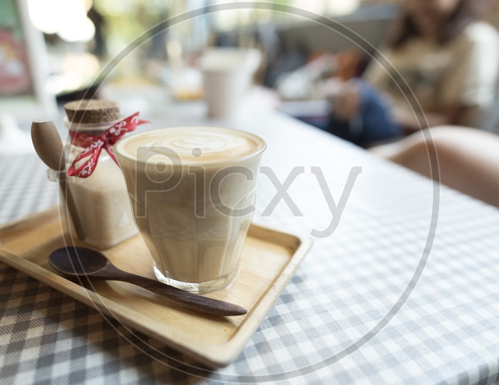 coffee latte art With Coffee Cup On a Cafe Table