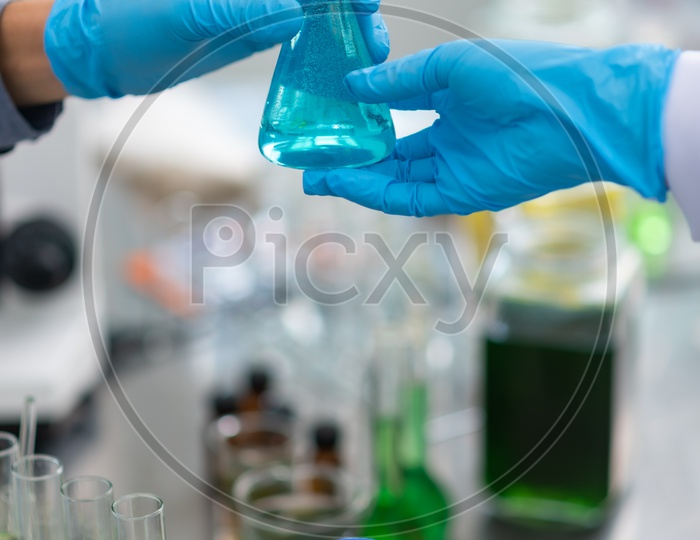 Asian Scientists Researching on Biofuel in a Test Tube at Laboratory