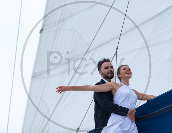Young Couple Celebrating  Wedding Anniversary on a yacht, Honeymoon Trip