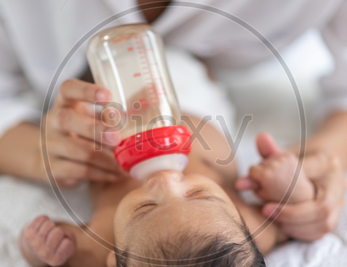 Asian Mother milk feeding using a baby bottle