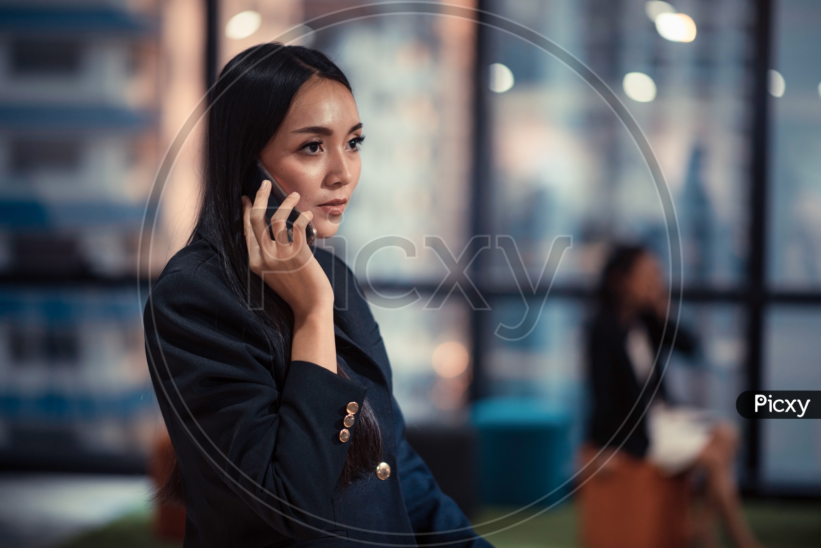 Young Asian Woman using Smartphone or Mobile in Office