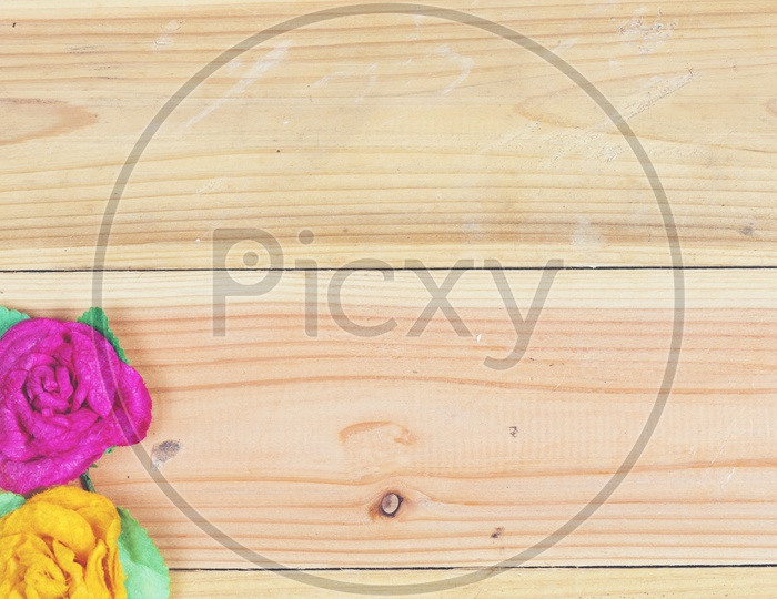 Colourful Flowers over a Wooden background With Spacing