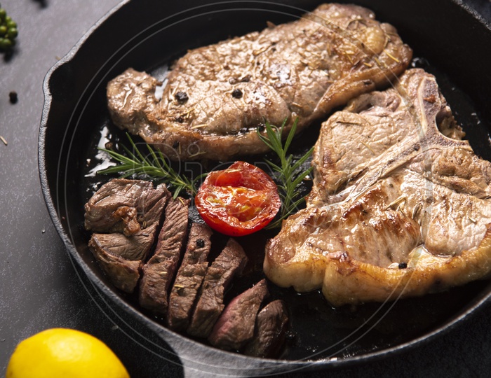 Colorful beef steaks and vegetable steaks in Black Pan