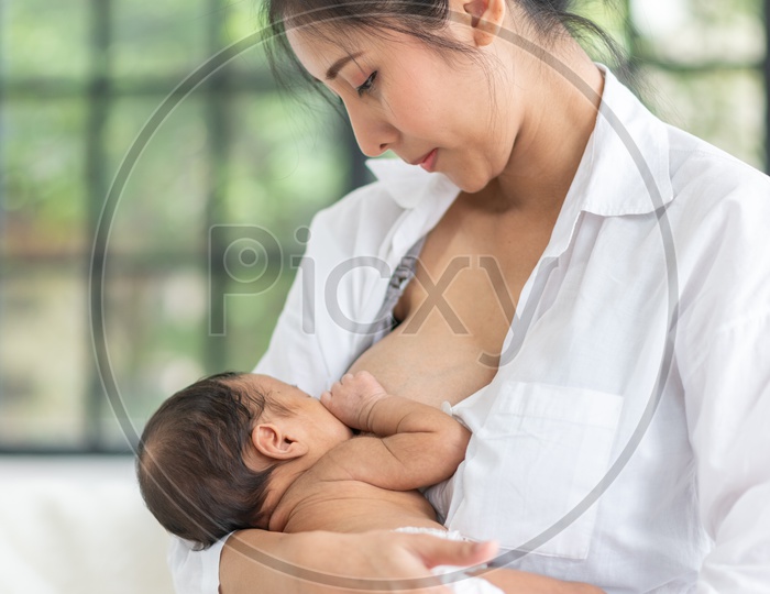 Asian Mother breastfeeding her baby