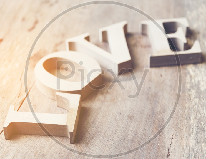 Wooden letters forming word LOVE on wooden background