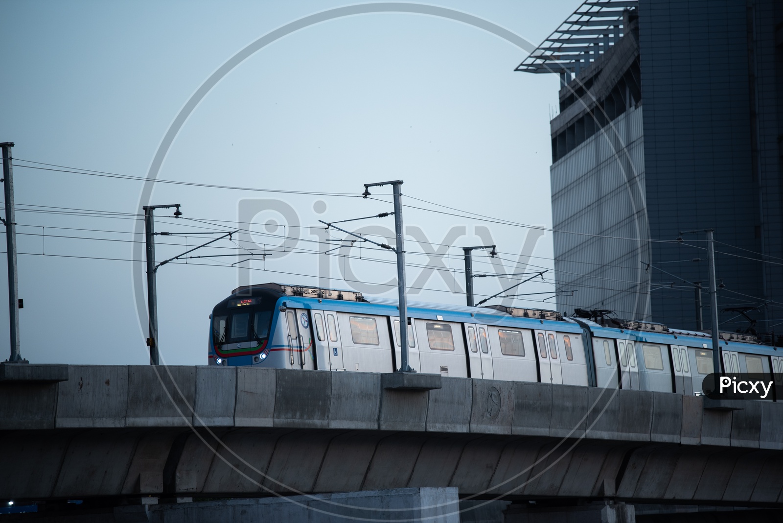 Metro Train Running On track With trident Hotel In Background