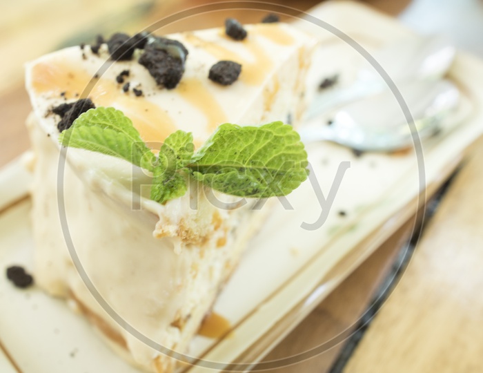 cheese cake  With Choco Chips And Mint leaf  on a Cafe Table Background