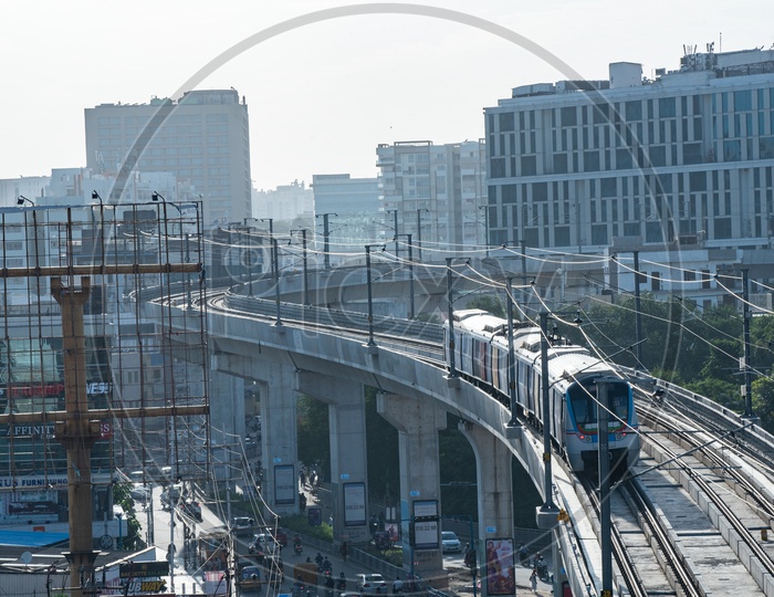 Hyderabad Metro train Running On Track With Buildings In Background