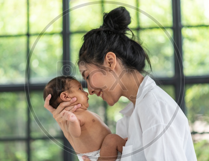 A young Asian mother holding a baby