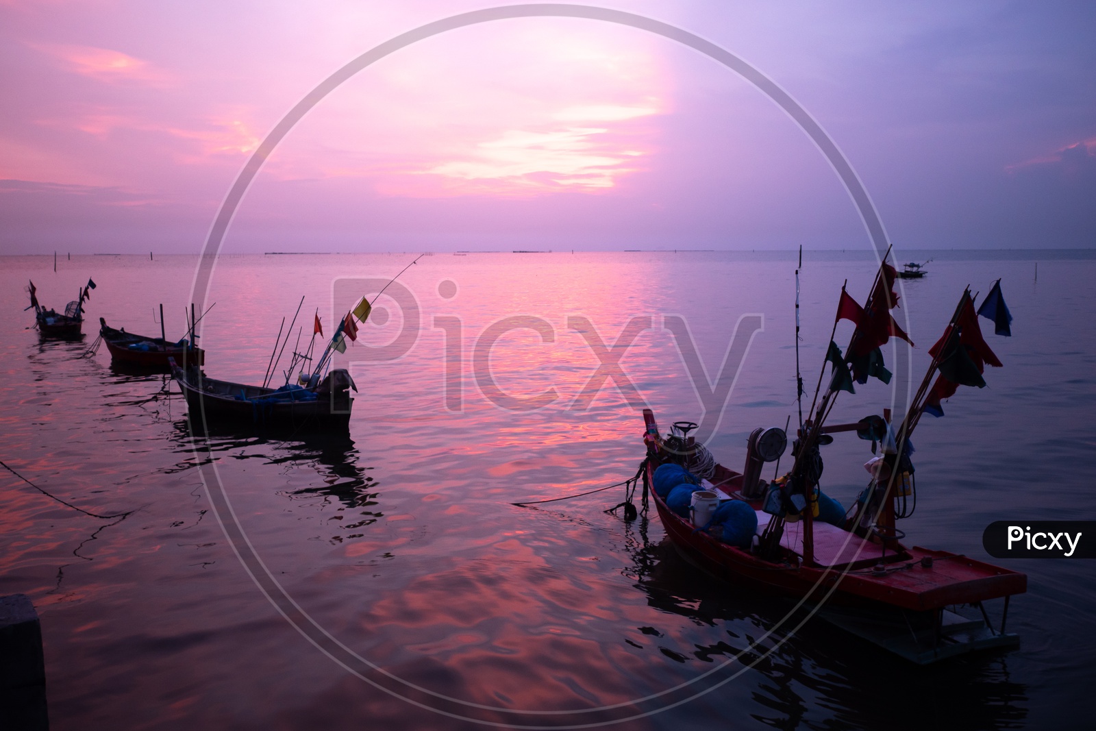 Local fishing boats during sunset hues in Thailand