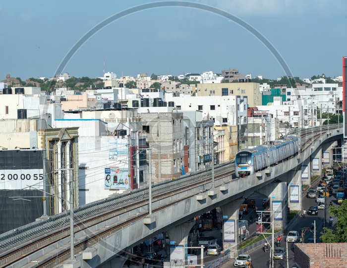 Hyderabad Metro Train running On Tracks  With High rise buildings View
