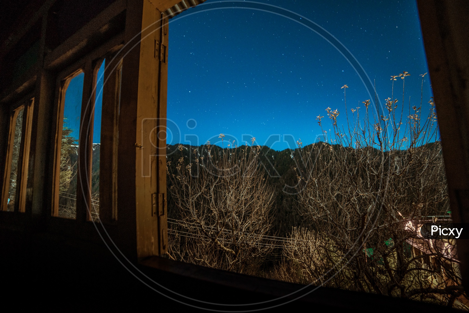 starry Sky view form the window of wooden hounse in himlayas