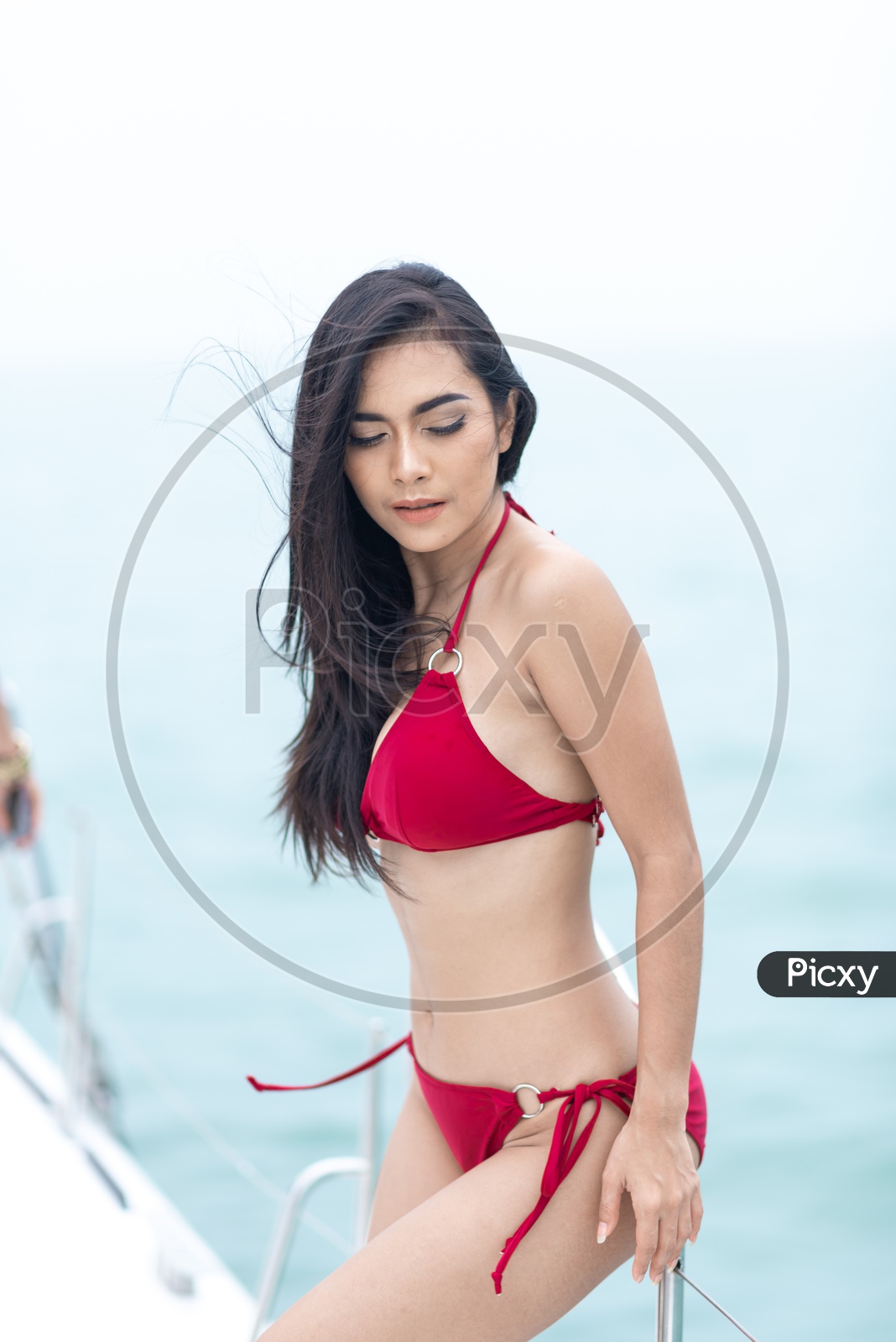 Asian Beautiful girl in Red Bikini on a yacht in Sea