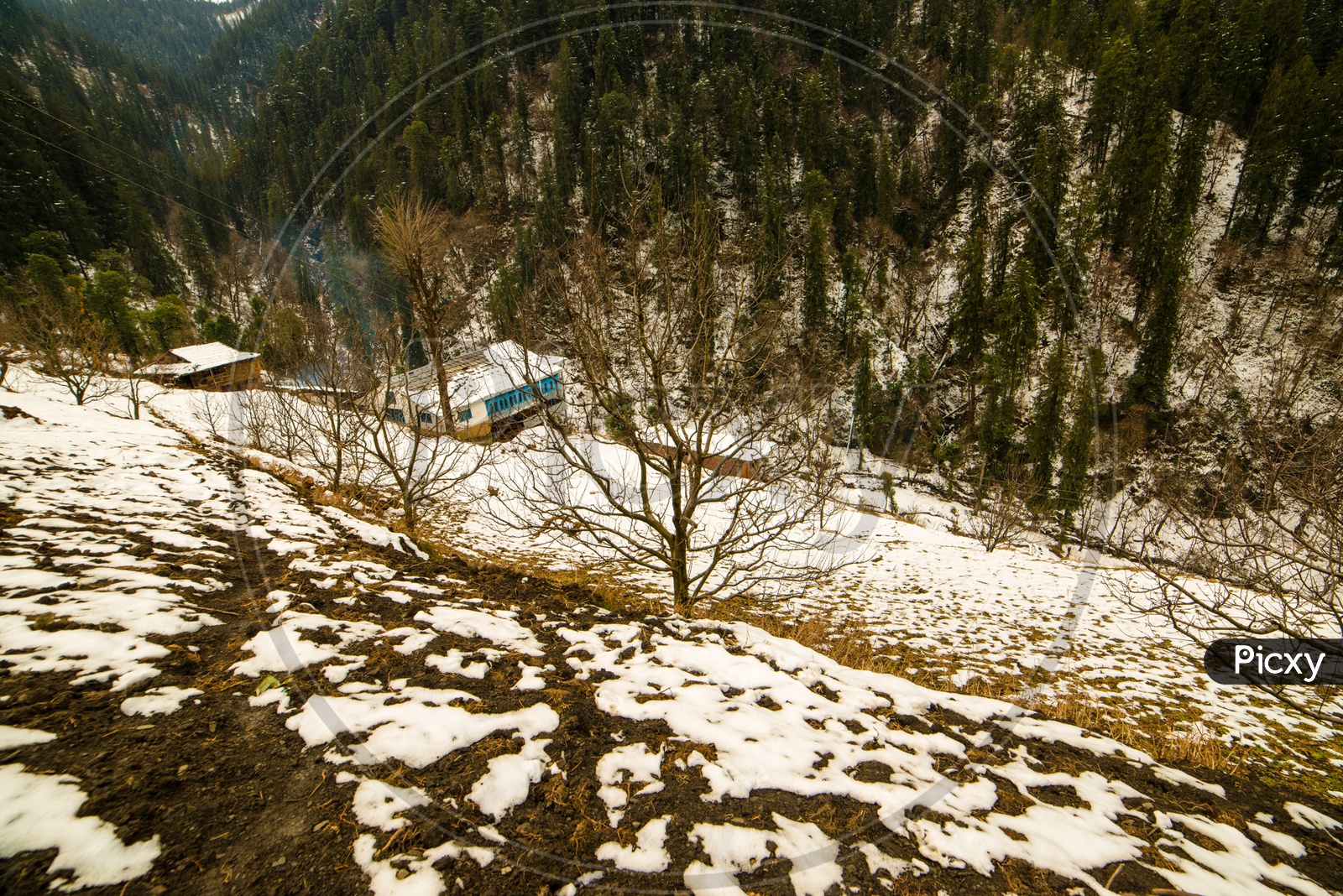 Houses Or Cottages In The Mountain Valleys Of Himalayas With Snow In Winter Season