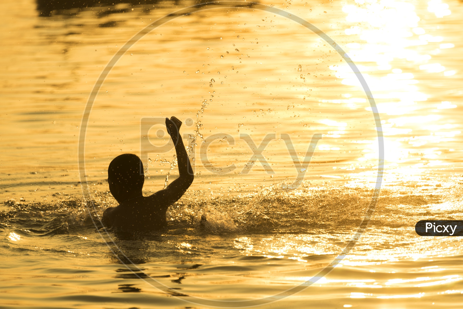 Silhouette of child  swimming in a Lake
