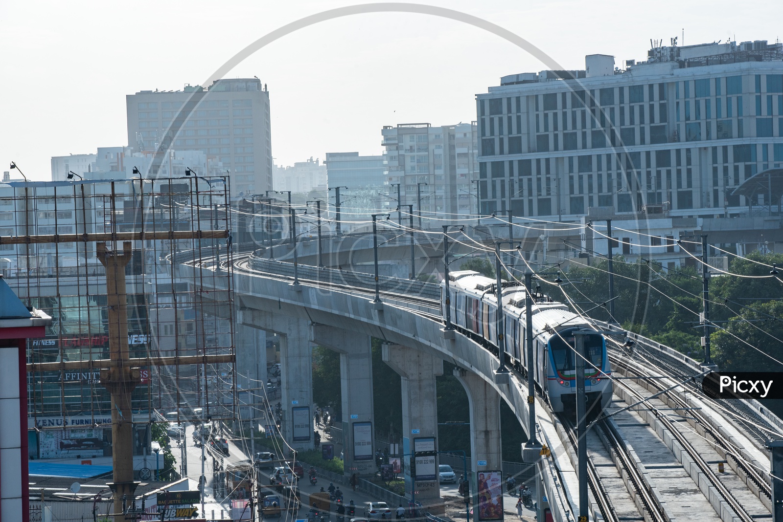Hyderabad Metro train Running On Track With Buildings In Background