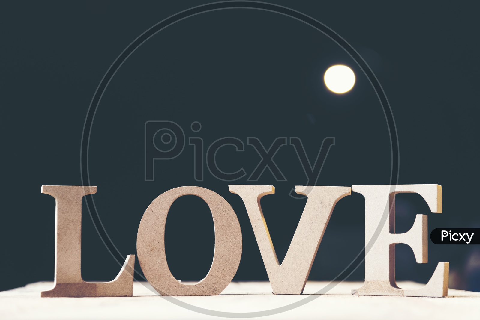 Wooden letters forming word LOVE with black background