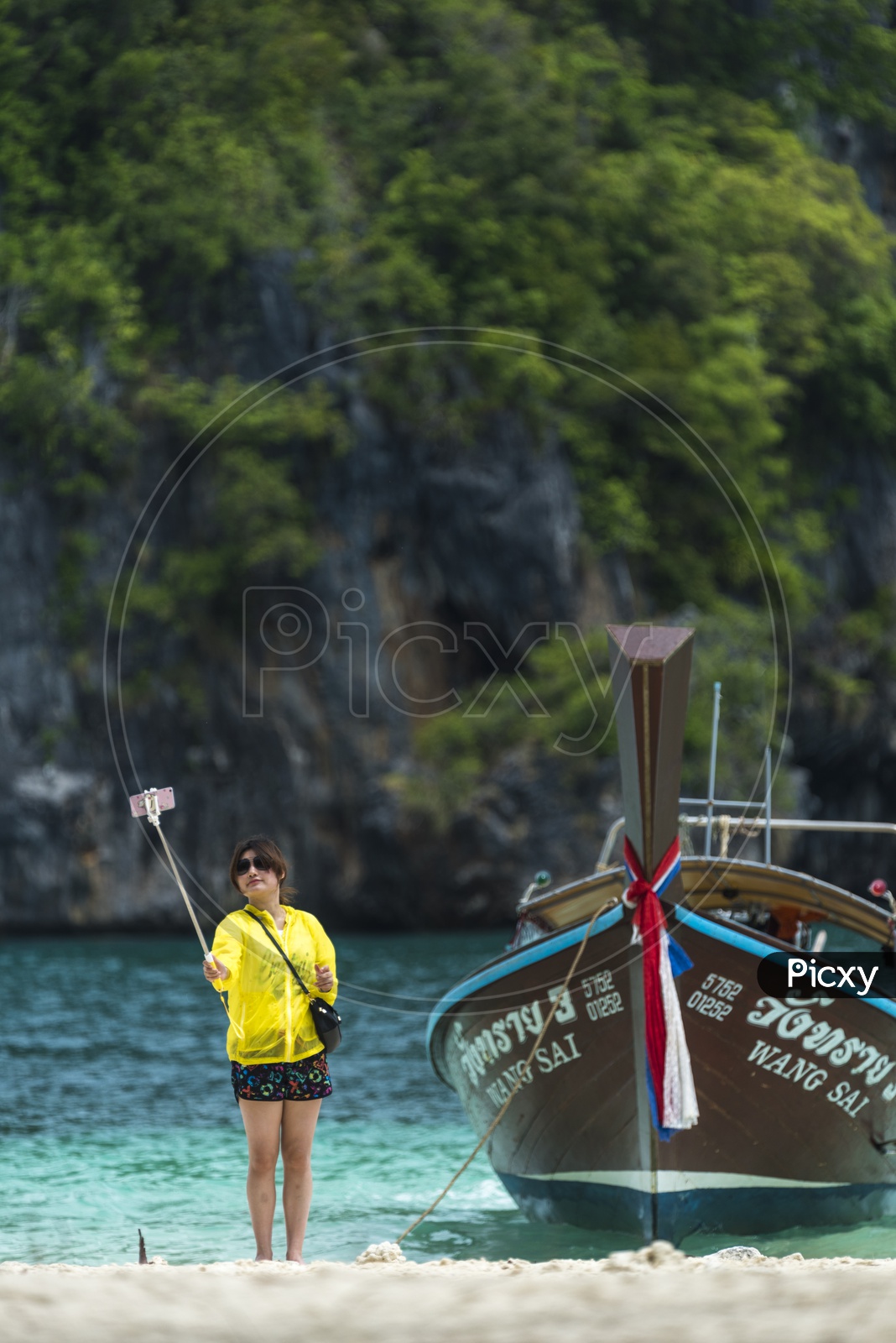 A Tourist taking selfie by the miracle beach at Krabi, Thaiand