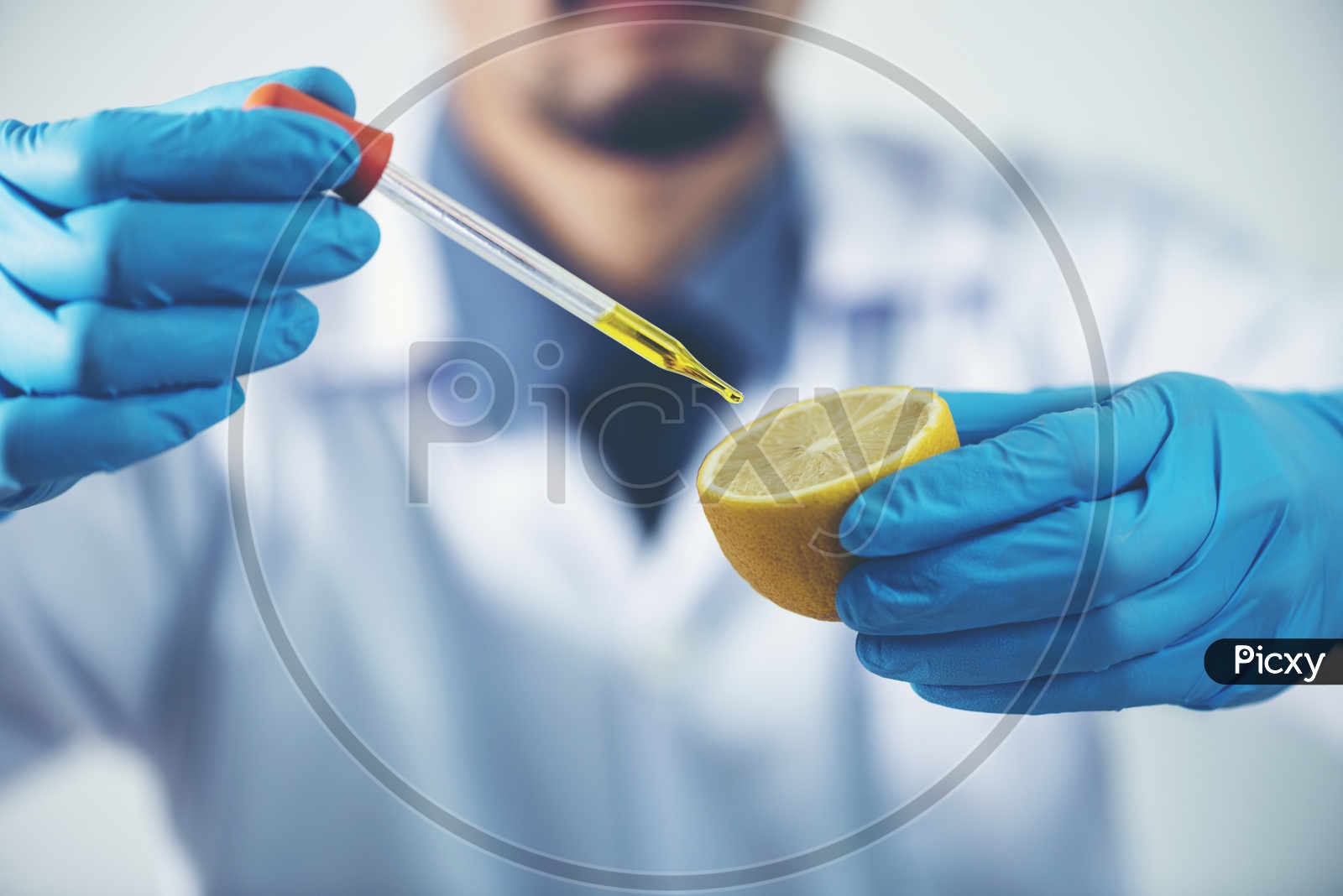Young Asian Male Scientist Researching on Skincare taking a Sample from Lemon at Laboratory