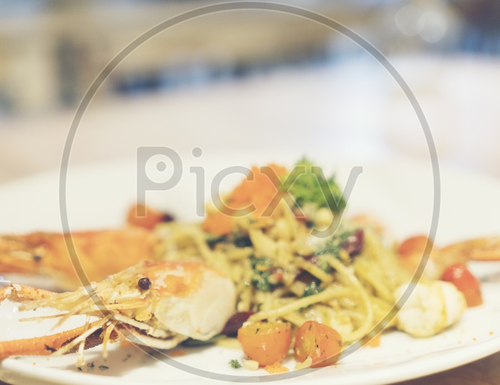 Spaghetti With Shrimp Served At a Restaurant With Wooden Table Background