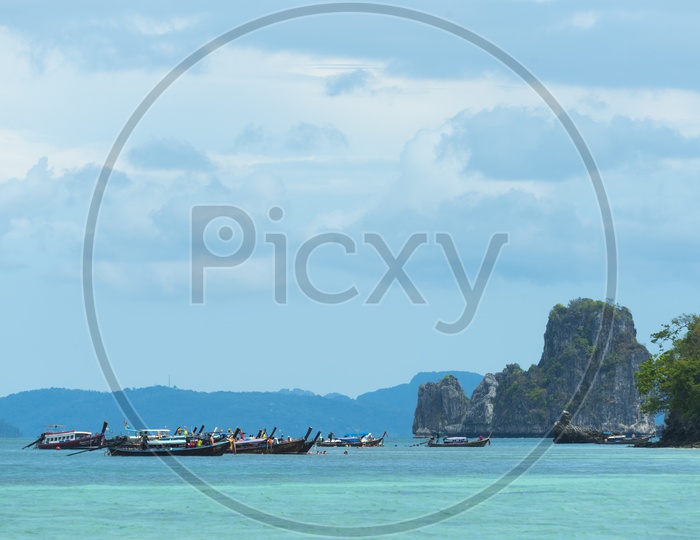 Tourist Boats Anchored At Krabi beach For Rock Formation Visits
