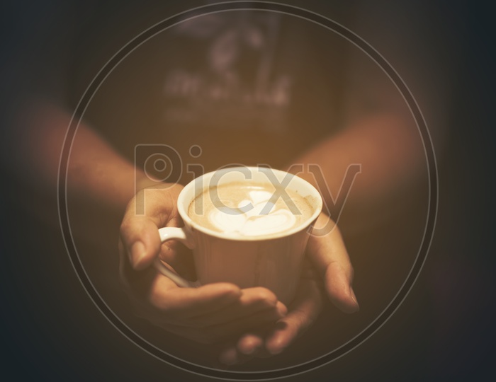 Hands Holding Coffee Cup With Latte Art