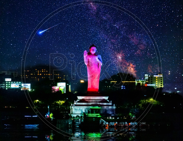 Lord Buddha Statue with milky way and full moon in the background