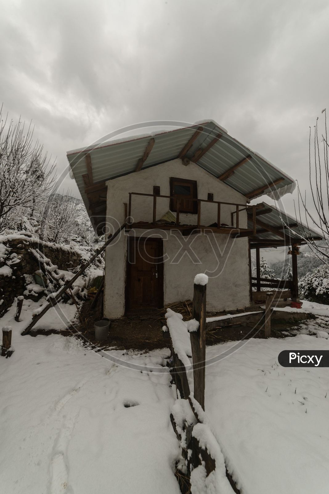 Snow covered wooden house in himalayas in winters - India